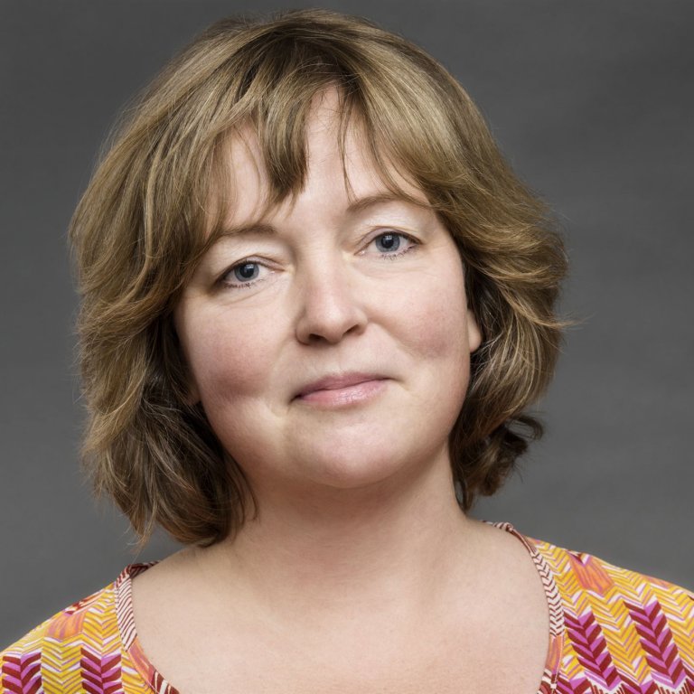 Lächelnde Frau mit braun-blonden Haaren portraitiert