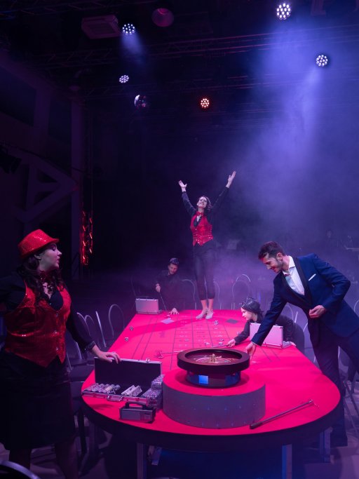 Violetta steht auf dem Roulette Tisch und breitet die Arme aus